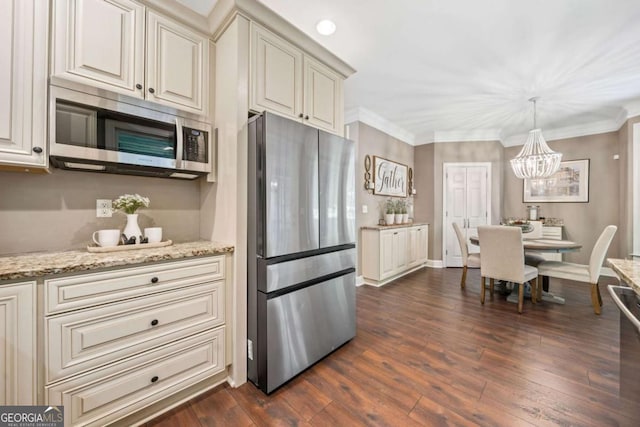 3232 Cates Ave NE, Brookhaven, GA 30319 - kitchen with stainless steel appliances, a chandelier, dark wood-type flooring, light stone countertops, and crown molding
