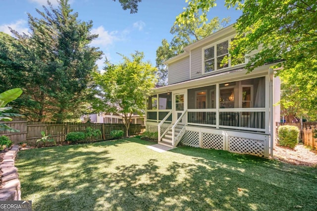 3232 Cates Ave NE, Brookhaven, GA 30319 - back of property featuring a fenced backyard and a sunroom