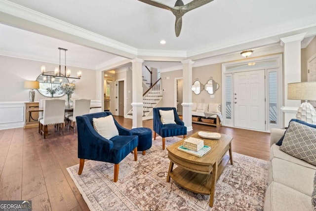 3232 Cates Ave NE, Brookhaven, GA 30319 - living room with decorative columns, wood-type flooring, a ceiling fan, crown molding, and stairs