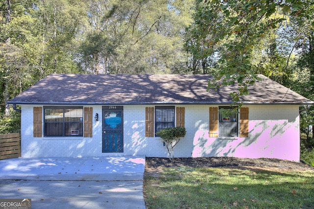 view of front of house featuring brick siding and a shingled roof