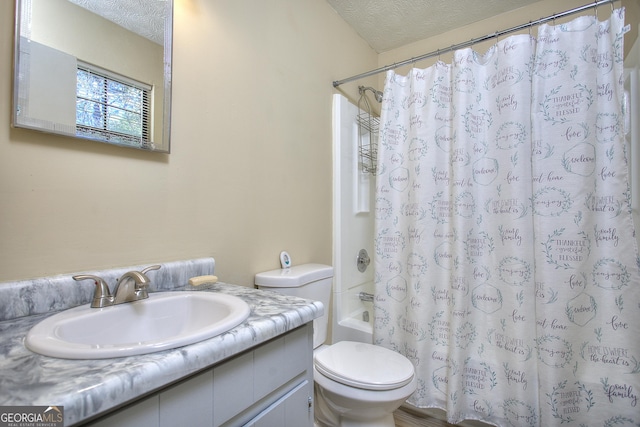 full bath featuring a textured ceiling, toilet, vanity, and shower / bath combo