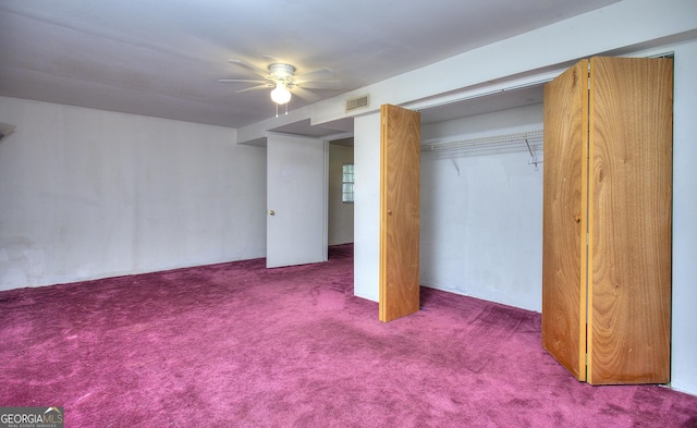 unfurnished bedroom with carpet, a ceiling fan, and a closet