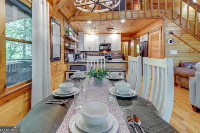 162 Little Falls Dr, Mineral Bluff, GA 30559 - dining area featuring wooden walls, light wood finished floors, and a chandelier