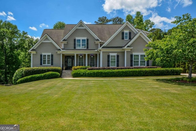 craftsman house with a front lawn and a porch