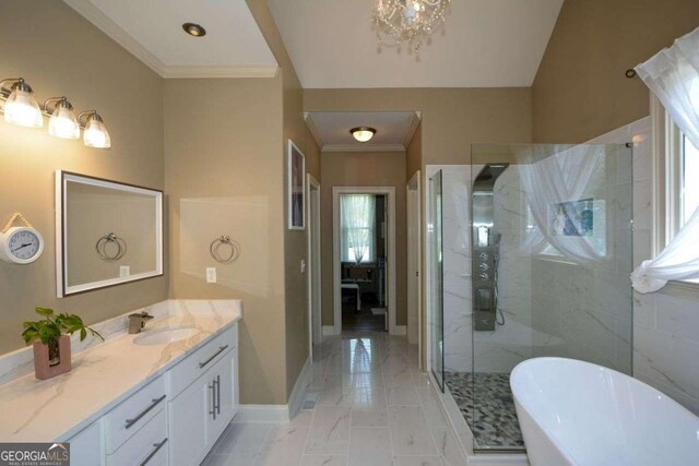 bathroom with a shower stall, a freestanding tub, vanity, baseboards, and crown molding