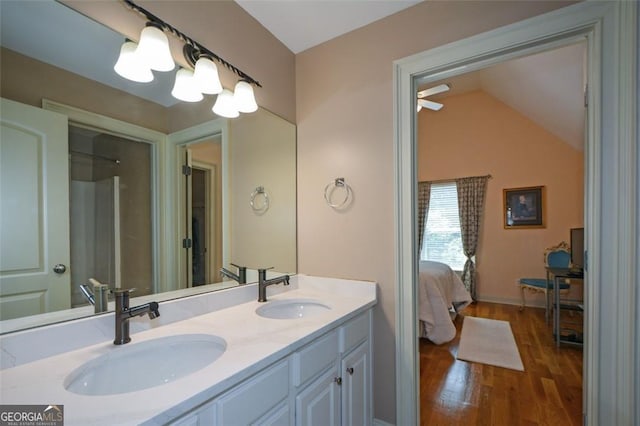 3740 Duckcove Way, Cumming, GA 30041 - bathroom with double vanity, wood finished floors, lofted ceiling, and ensuite bathroom