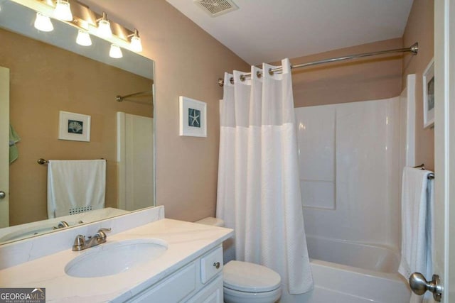 bathroom featuring toilet, shower / tub combo with curtain, and vanity