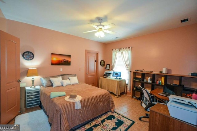 bedroom featuring a desk, a ceiling fan, and light tile patterned floors