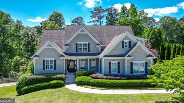 craftsman-style home with a front yard and covered porch