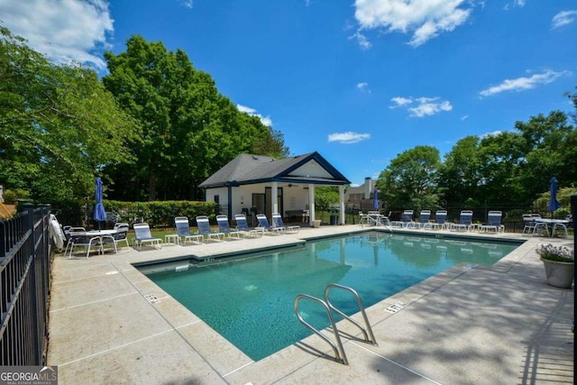 community pool featuring a patio and fence
