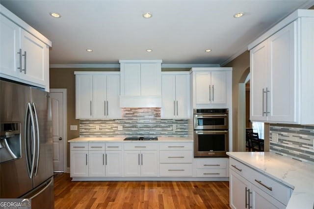 3740 Duckcove Way, Cumming, GA 30041 - kitchen featuring stainless steel appliances, tasteful backsplash, ornamental molding, white cabinets, and light wood finished floors