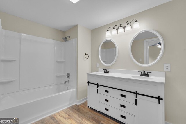 245 N Terrell St, Metter, GA 30439 - bathroom featuring wood finished floors, double vanity, bathtub / shower combination, and baseboards