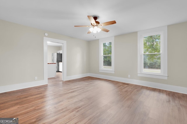 245 N Terrell St, Metter, GA 30439 - unfurnished room with light wood-style flooring, ceiling fan, and baseboards