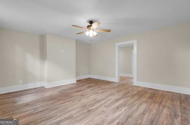 245 N Terrell St, Metter, GA 30439 - unfurnished room featuring a ceiling fan, light wood-style floors, and baseboards