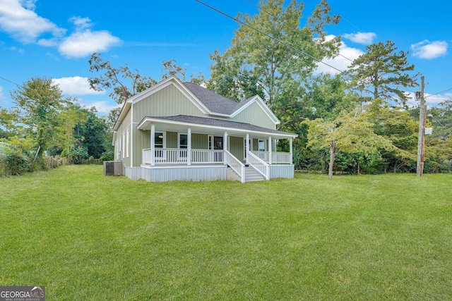 245 N Terrell St, Metter, GA 30439 - view of front facade featuring covered porch, a front yard, a shingled roof, central AC, and board and batten siding