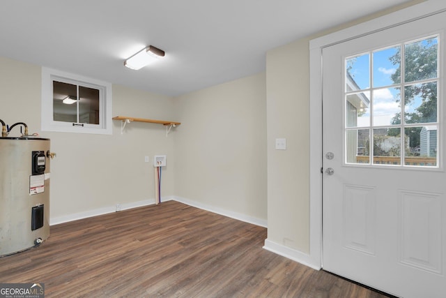 245 N Terrell St, Metter, GA 30439 - basement featuring water heater, wood finished floors, and baseboards