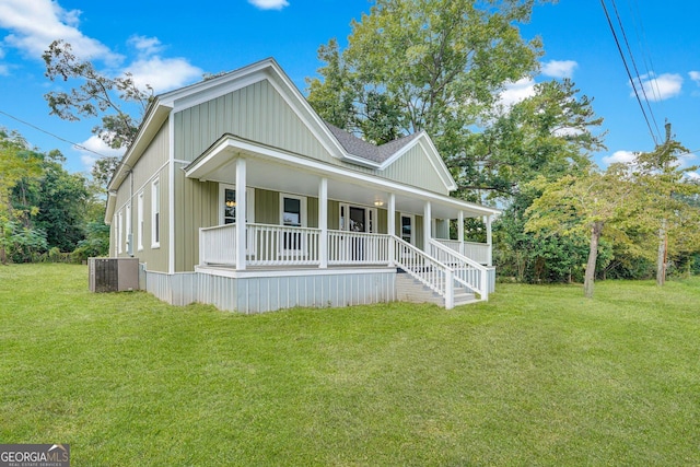 245 N Terrell St, Metter, GA 30439 - view of front of house with a porch, central AC, a front yard, and board and batten siding