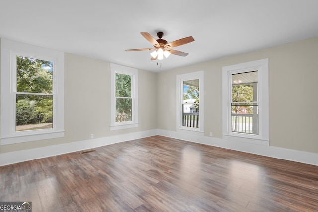 245 N Terrell St, Metter, GA 30439 - empty room featuring plenty of natural light, wood finished floors, and ceiling fan