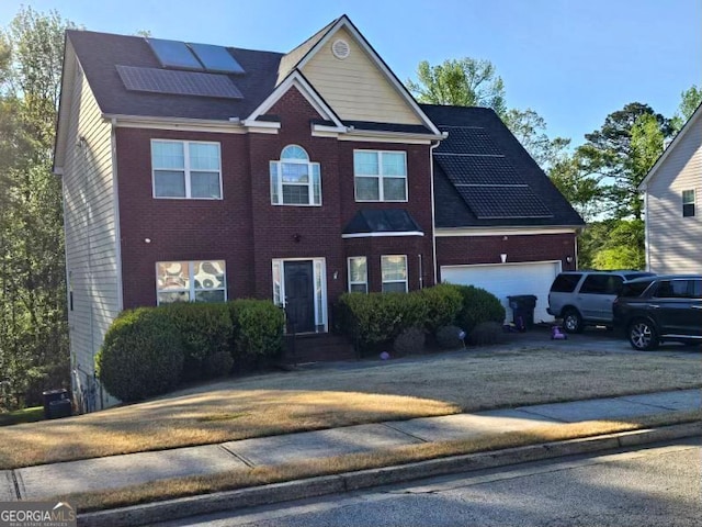 230 Shiver Blvd, Covington, GA 30016 - view of front of property with roof mounted solar panels, concrete driveway, a garage, and brick siding