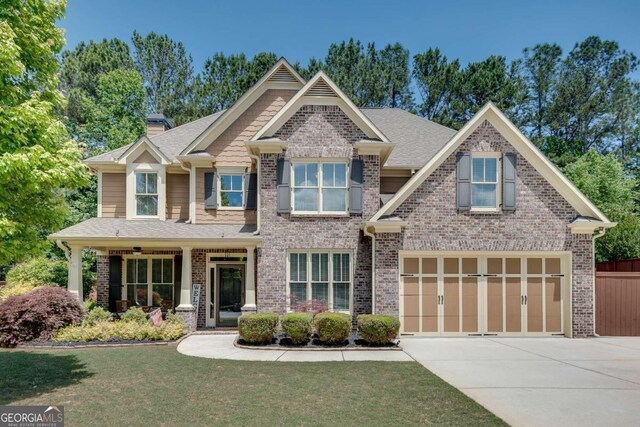 craftsman inspired home with concrete driveway, brick siding, and a chimney
