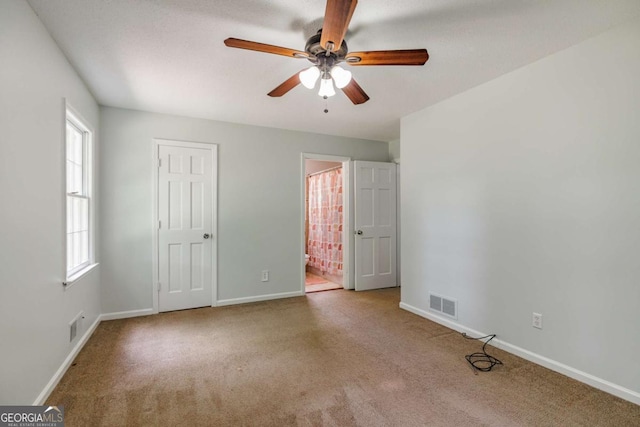 unfurnished bedroom featuring carpet flooring, baseboards, and connected bathroom