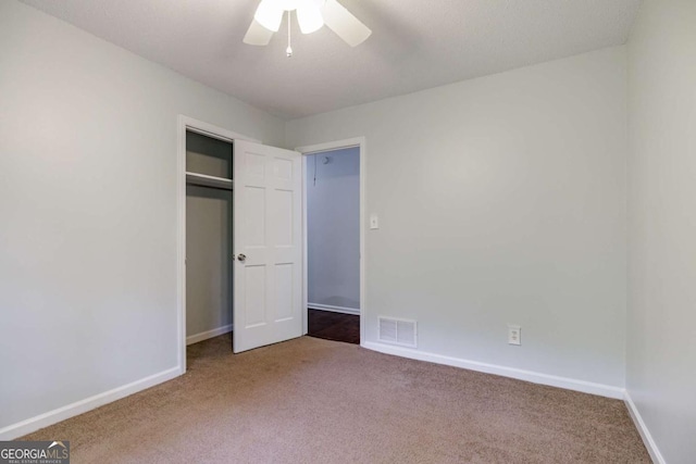 unfurnished bedroom featuring carpet, baseboards, and a closet