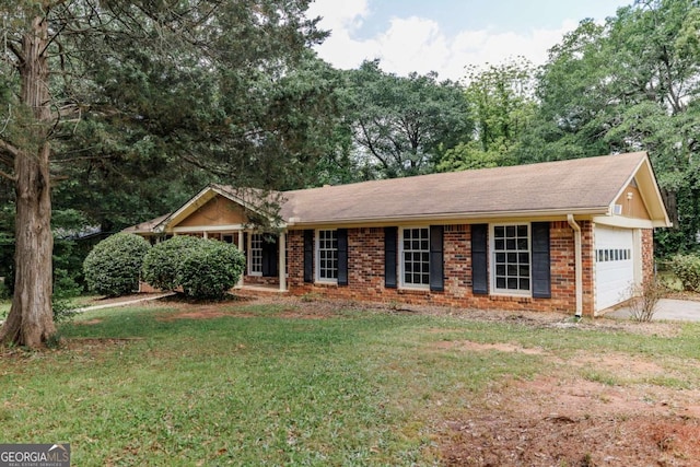 ranch-style home with a garage, brick siding, a front lawn, and driveway