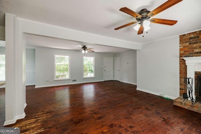 unfurnished living room featuring ceiling fan, hardwood / wood-style floors, a brick fireplace, baseboards, and ornamental molding
