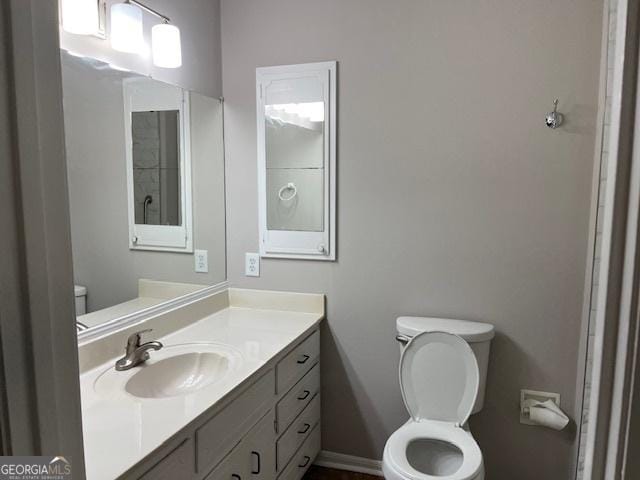 bathroom featuring toilet and vanity