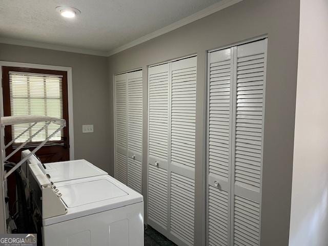 laundry room featuring washer and clothes dryer and ornamental molding