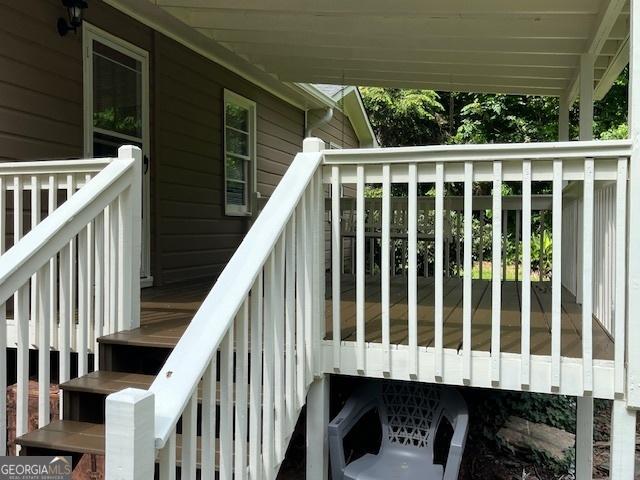 wooden terrace featuring stairway