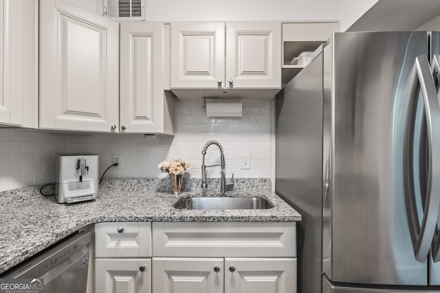 120 Biscayne Dr NW Unit C13, Atlanta, GA 30309 - kitchen with stainless steel appliances, a sink, white cabinets, and backsplash