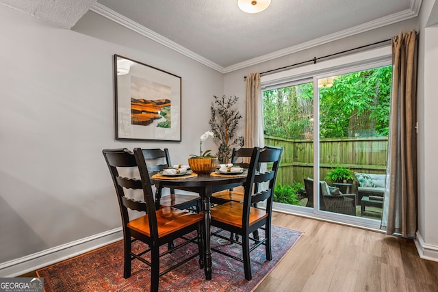 120 Biscayne Dr NW Unit C13, Atlanta, GA 30309 - dining room featuring wood finished floors, ornamental molding, a textured ceiling, and baseboards