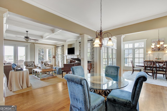 dining space with decorative columns, a ceiling fan, light wood-style flooring, ornamental molding, and coffered ceiling