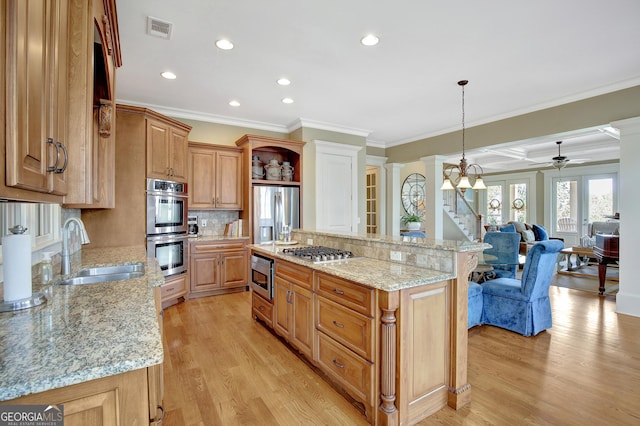 kitchen featuring a sink, open shelves, appliances with stainless steel finishes, ornamental molding, and light wood finished floors