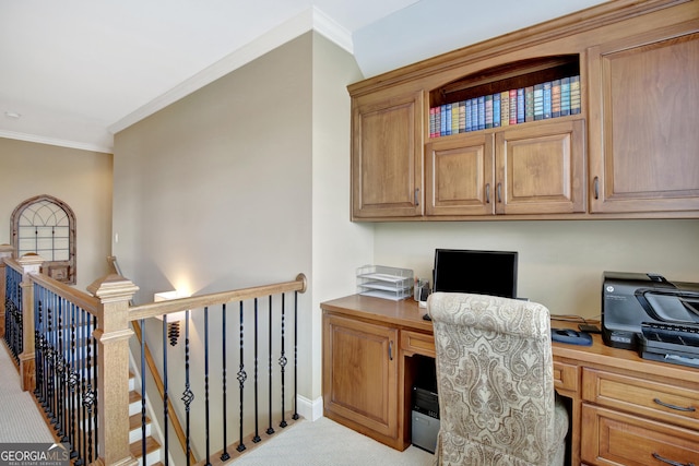 office space featuring built in study area, crown molding, carpet floors, and baseboards