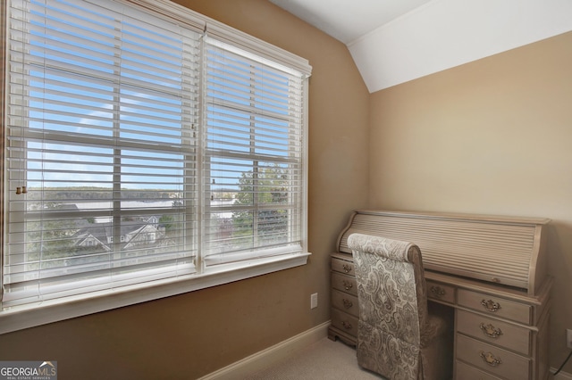 office area with lofted ceiling, baseboards, and carpet