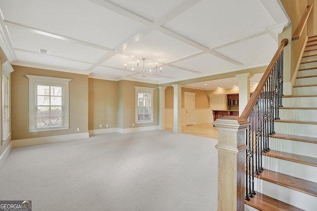 unfurnished living room featuring coffered ceiling, a chandelier, stairway, light colored carpet, and healthy amount of natural light