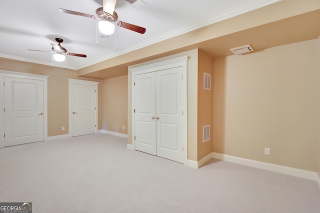 additional living space featuring a ceiling fan, light colored carpet, and baseboards
