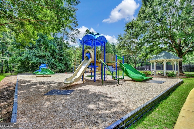 community jungle gym featuring fence and view of scattered trees
