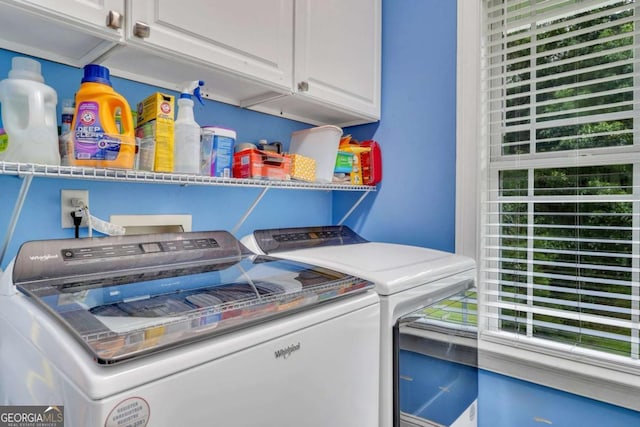 washroom with independent washer and dryer and cabinet space