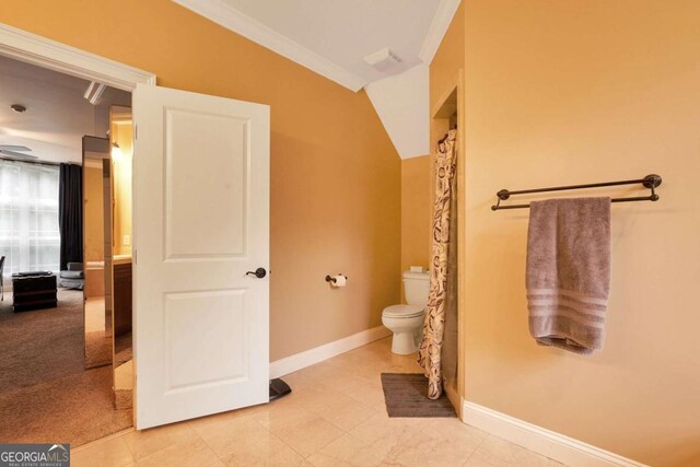 bathroom with toilet and baseboards
