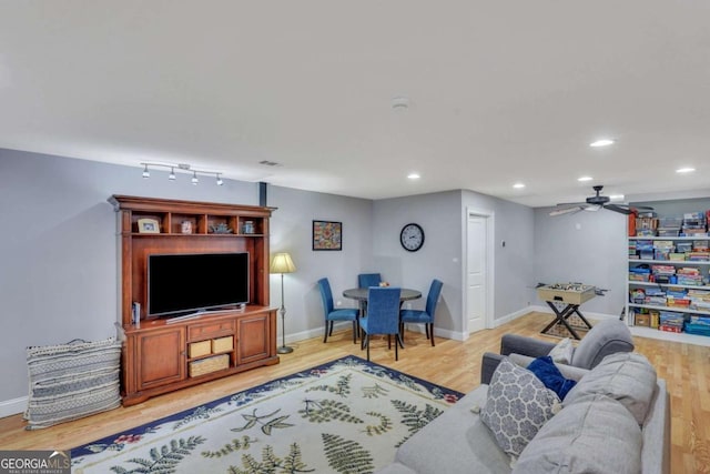 living room featuring light wood-type flooring, recessed lighting, a ceiling fan, and baseboards