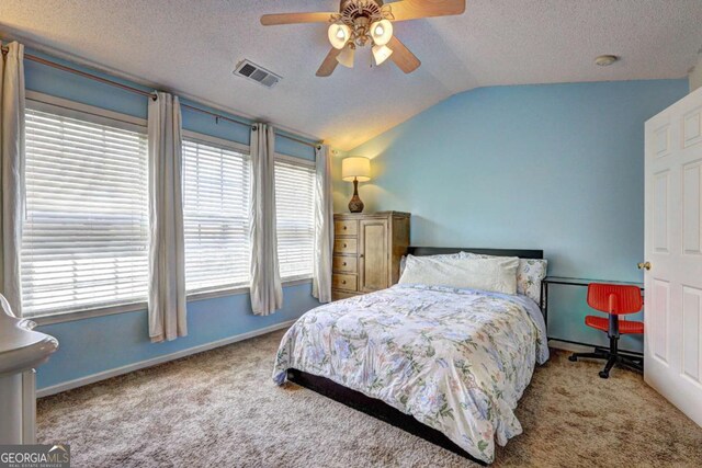 10900 Wittenridge Dr Unit L6, Alpharetta, GA 30022 - carpeted bedroom featuring lofted ceiling, multiple windows, a textured ceiling, baseboards, and ceiling fan