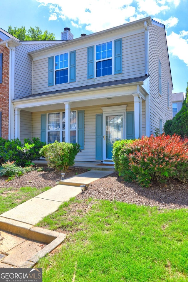 10900 Wittenridge Dr Unit L6, Alpharetta, GA 30022 - view of front of house featuring a chimney, covered porch, and a front lawn