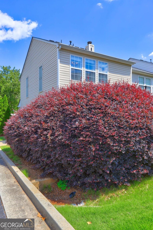 10900 Wittenridge Dr Unit L6, Alpharetta, GA 30022 - view of home's exterior with a chimney