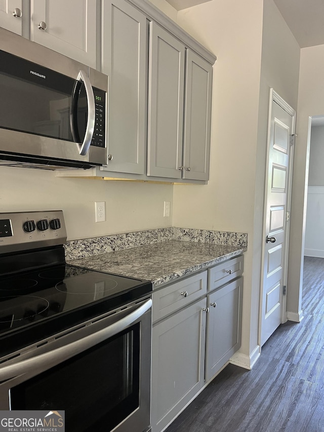 131 Queens Cemetery Rd, Good Hope, GA 30641 - kitchen featuring stainless steel appliances, dark wood-type flooring, baseboards, and light stone counters