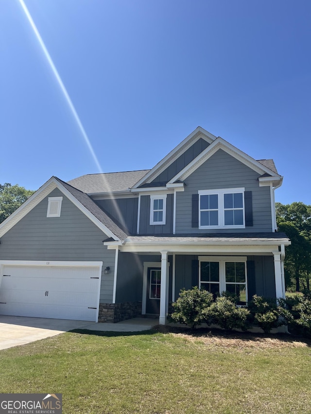 131 Queens Cemetery Rd, Good Hope, GA 30641 - craftsman house with board and batten siding, a garage, a front lawn, concrete driveway, and covered porch