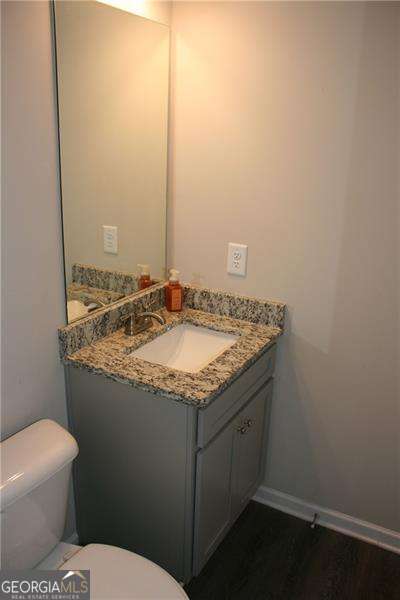 131 Queens Cemetery Rd, Good Hope, GA 30641 - bathroom with toilet, vanity, baseboards, and wood finished floors