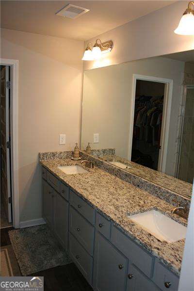 131 Queens Cemetery Rd, Good Hope, GA 30641 - full bath with a walk in closet, double vanity, and a stall shower